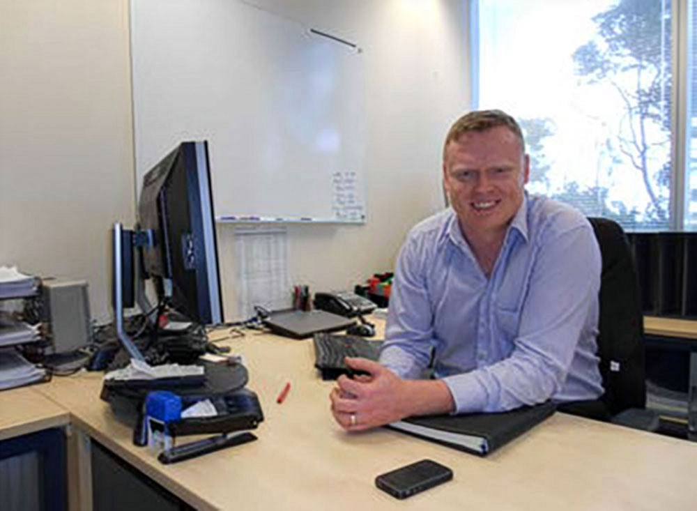 Man smiling at desk in office