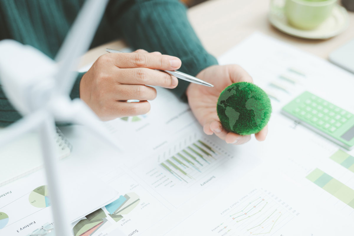 Analysing sustainability data with globe model and pen.