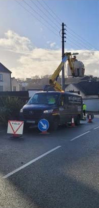 Utility vehicle repairing overhead lines on street