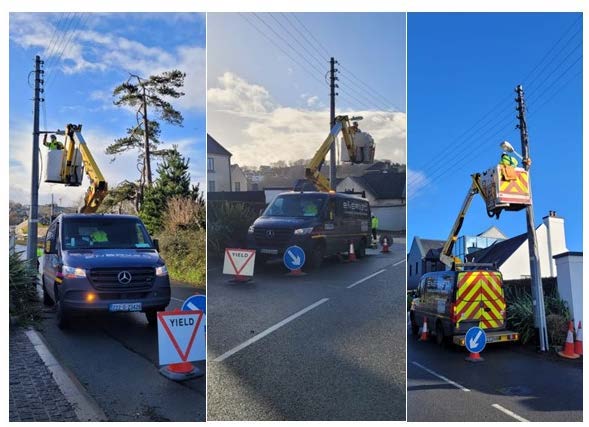 Workers repairing electrical lines from cherry pickers.