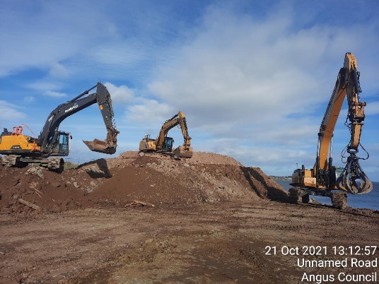 Three excavators working on a construction site.