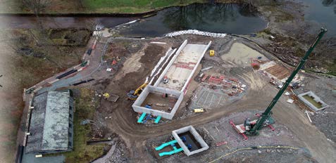 Aerial view of construction site by river.
